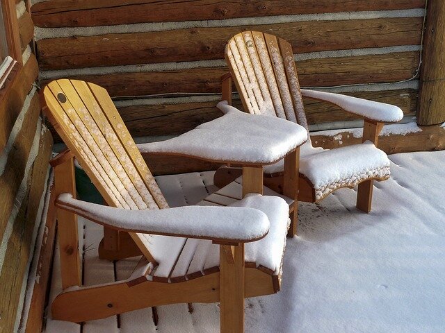 Picture of 2 Adirondack chairs covered in snow