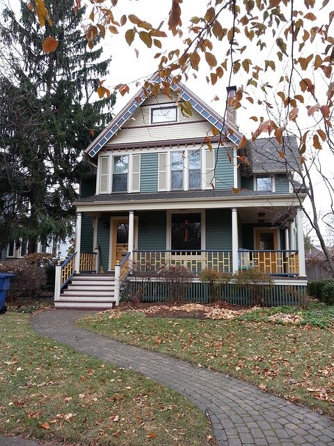 House with front porch and fall leaves on the ground